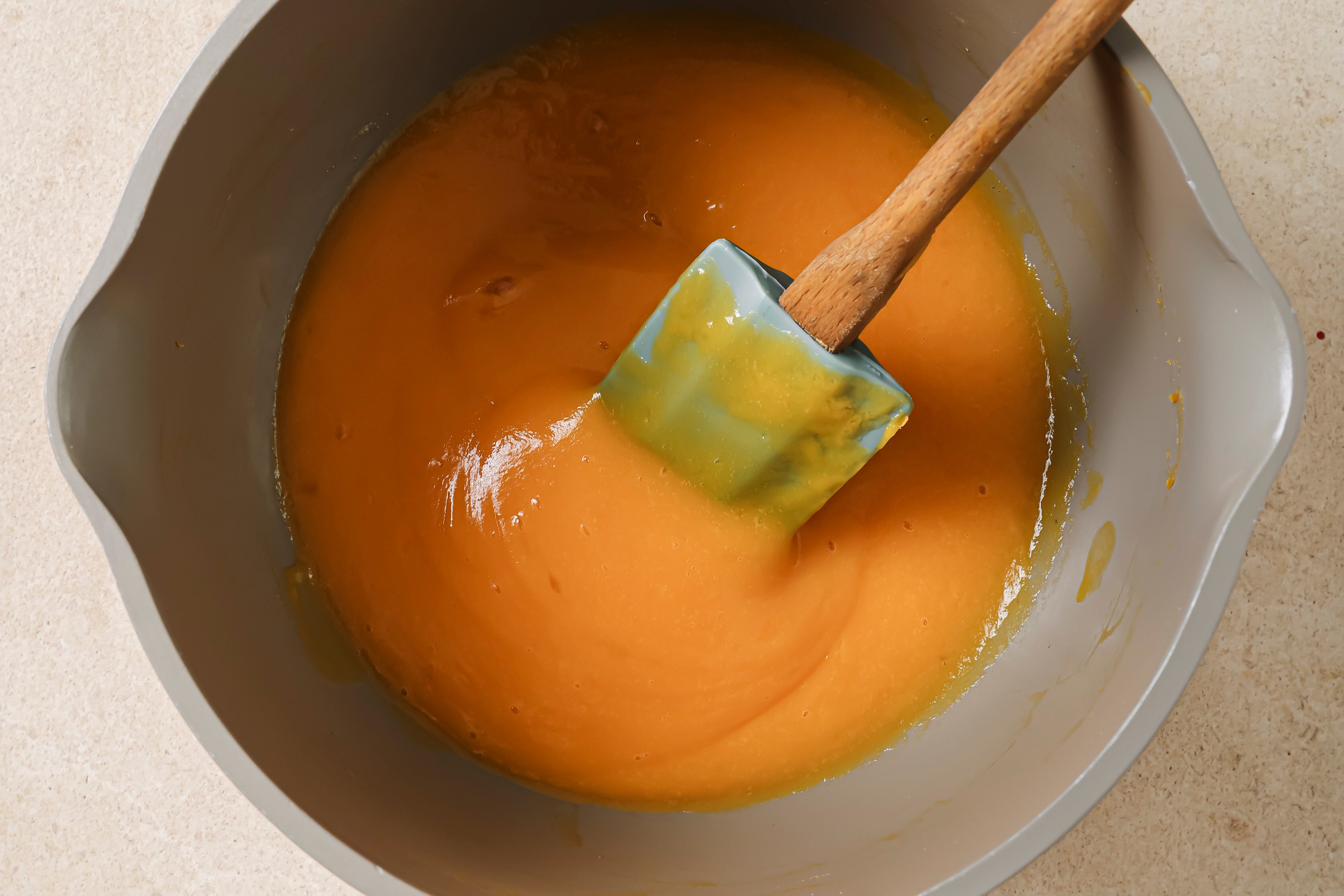 A pot with the fruit and vegetable juice with honey added.