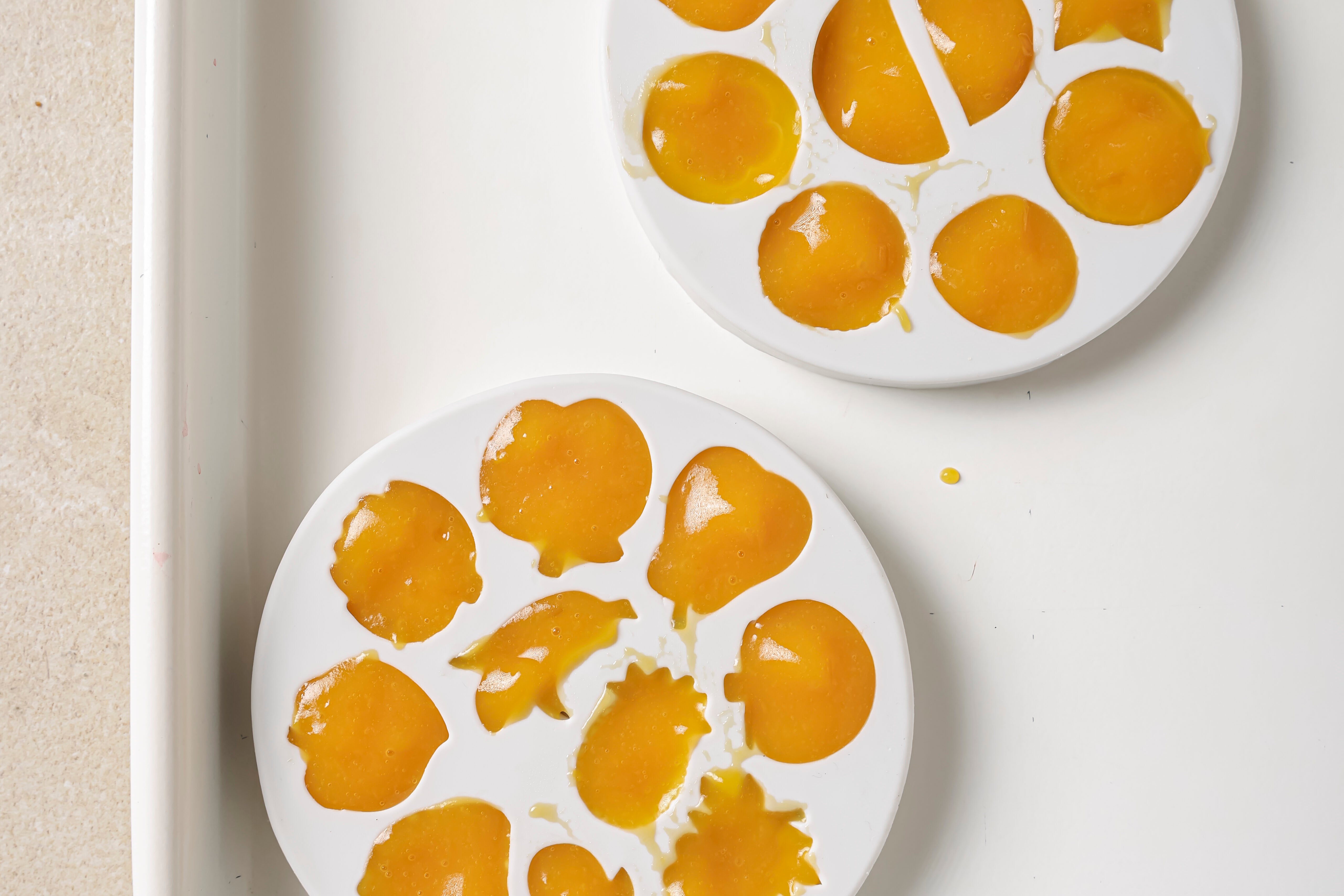White molds filled with fruit and vegetable mixture before hardening.