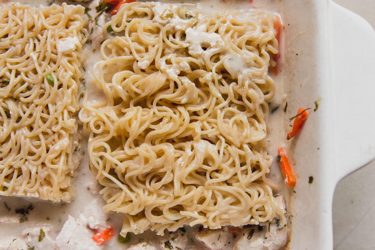 The casserole dish with ramen, vegetables and chicken with arrowroot starch and chicken broth poured over it.