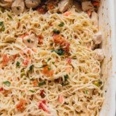 Bacon ranch ramen bake topped with parsley and bacon in a large casserole dish.