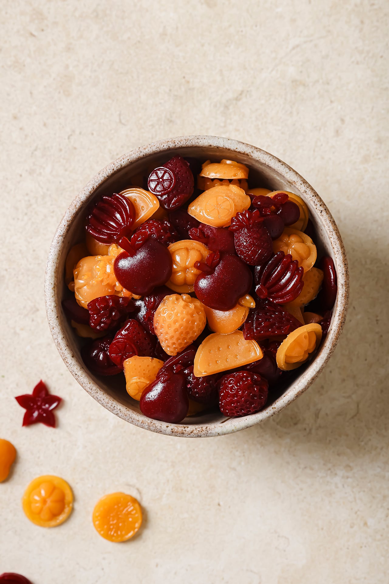 Fruit and veggie gummies in a small bowl.