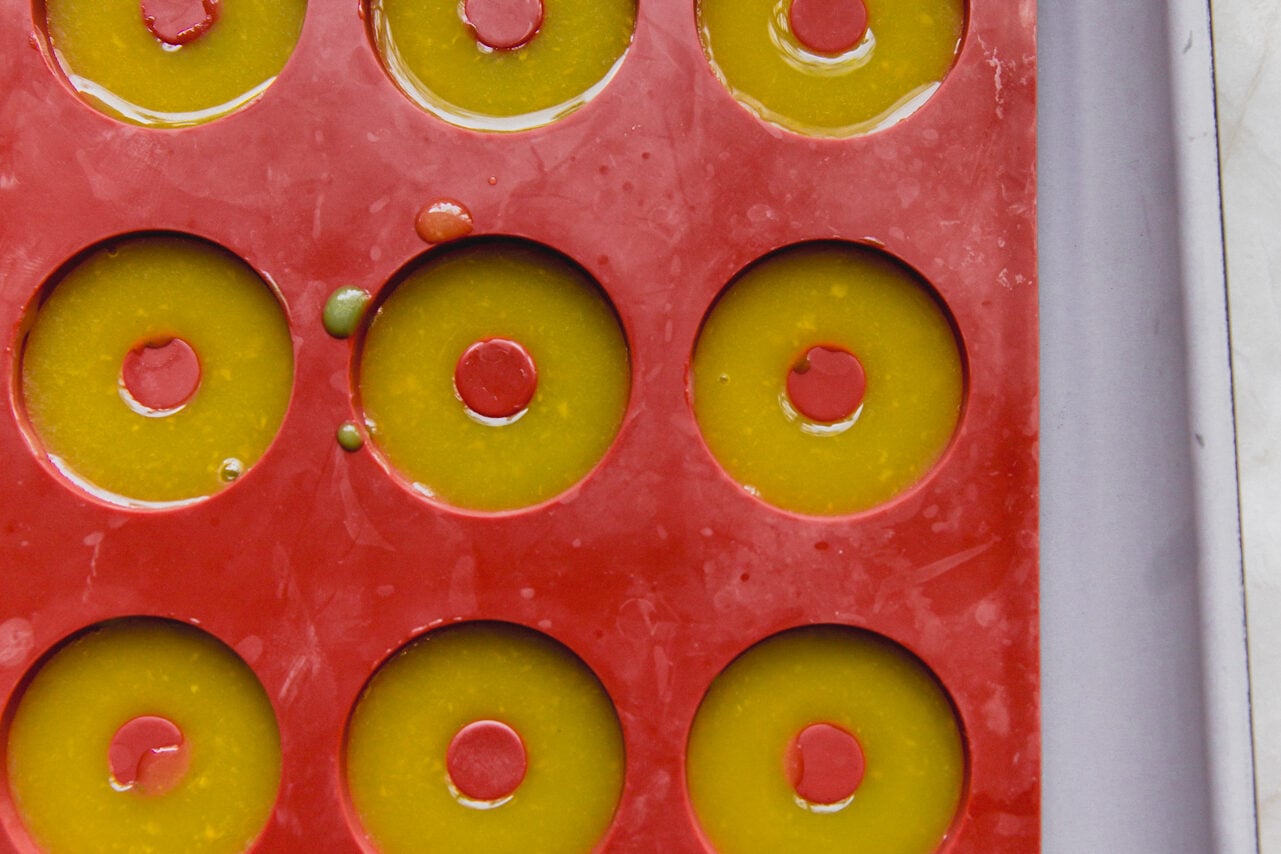 A mold filled with the orange mango mixture before refrigerating.
