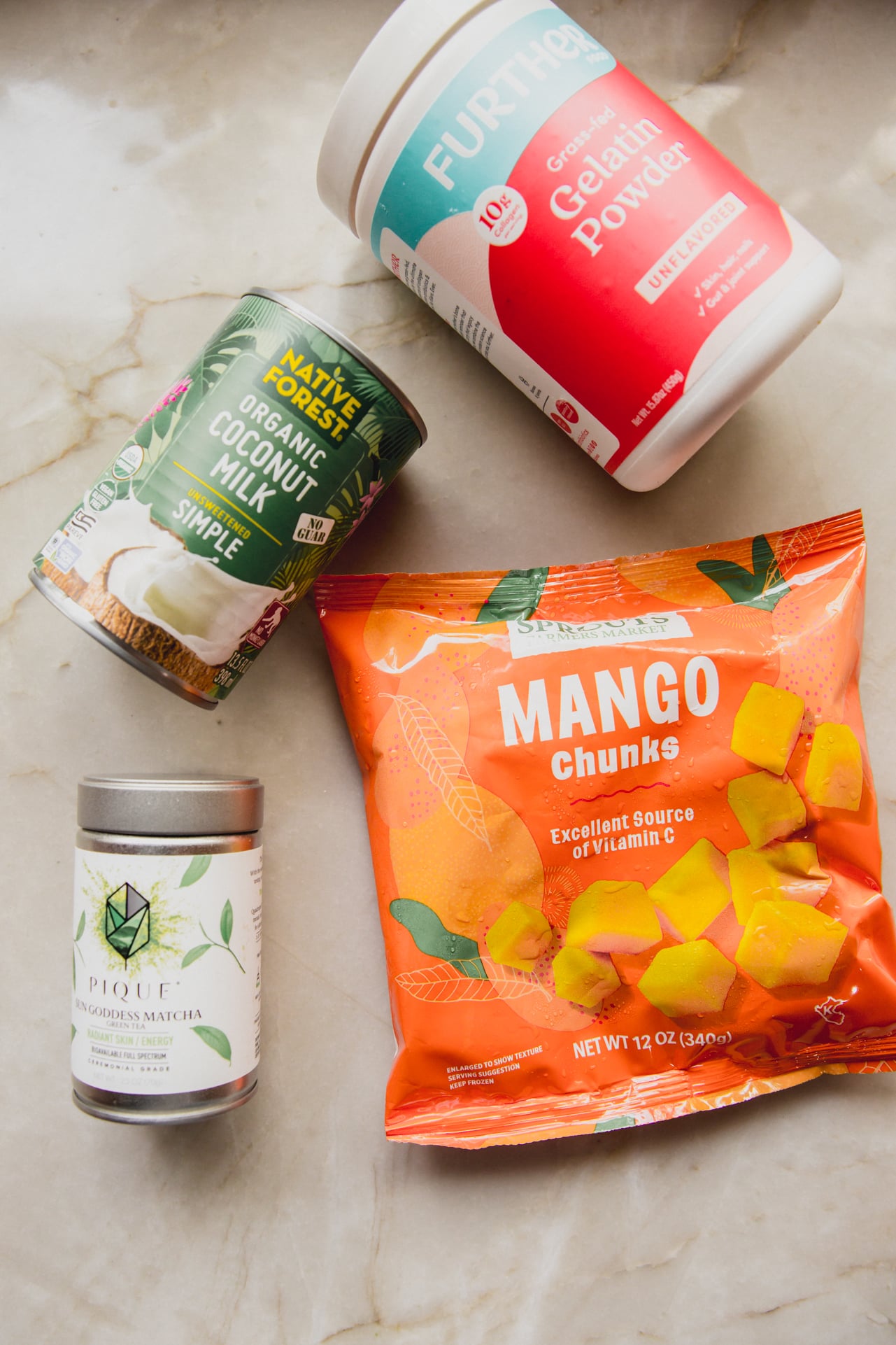 The main ingredients needed to make the matcha mango gummies laid out on the counter.