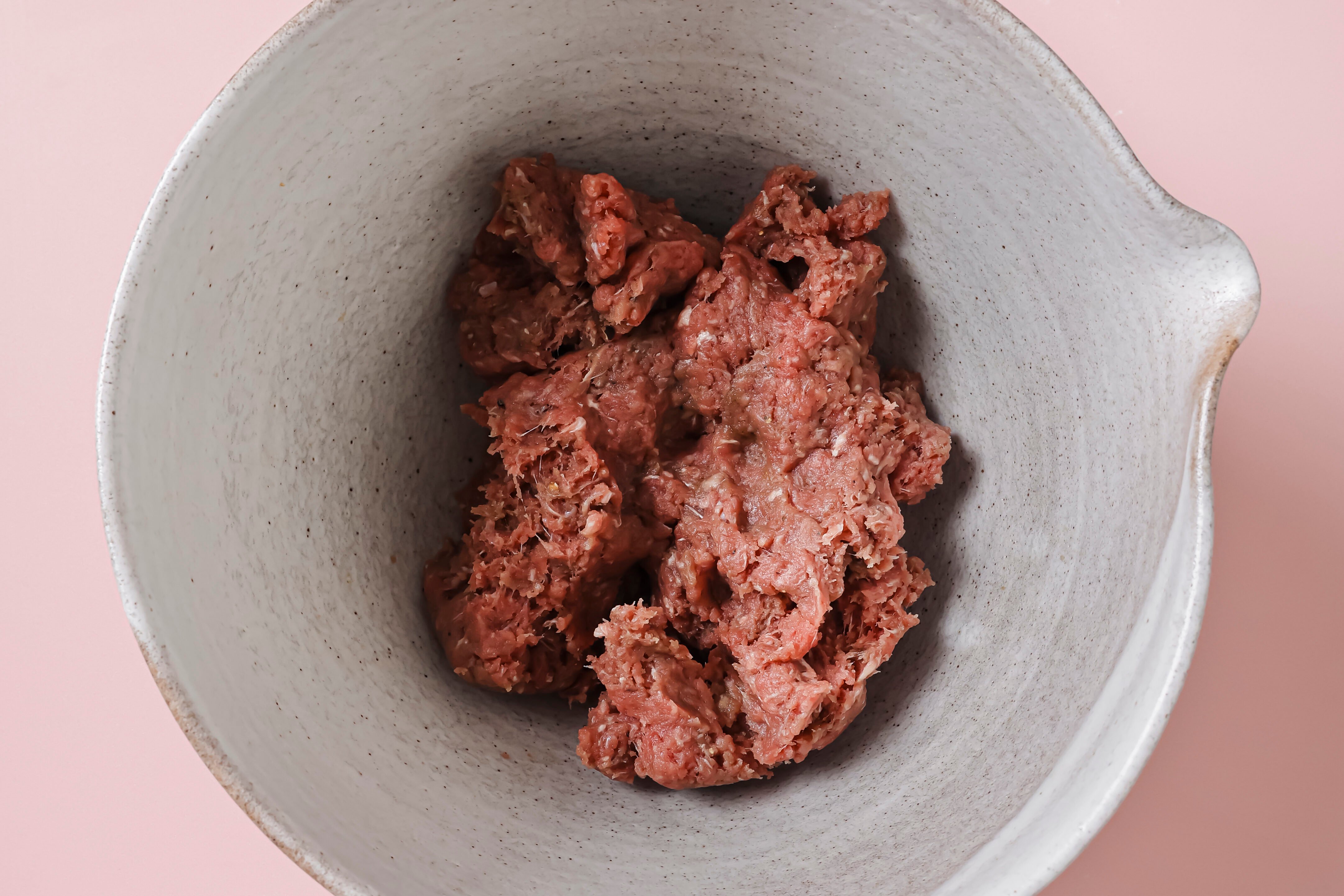 Ground beef and seasonings in a bowl, fully mixed