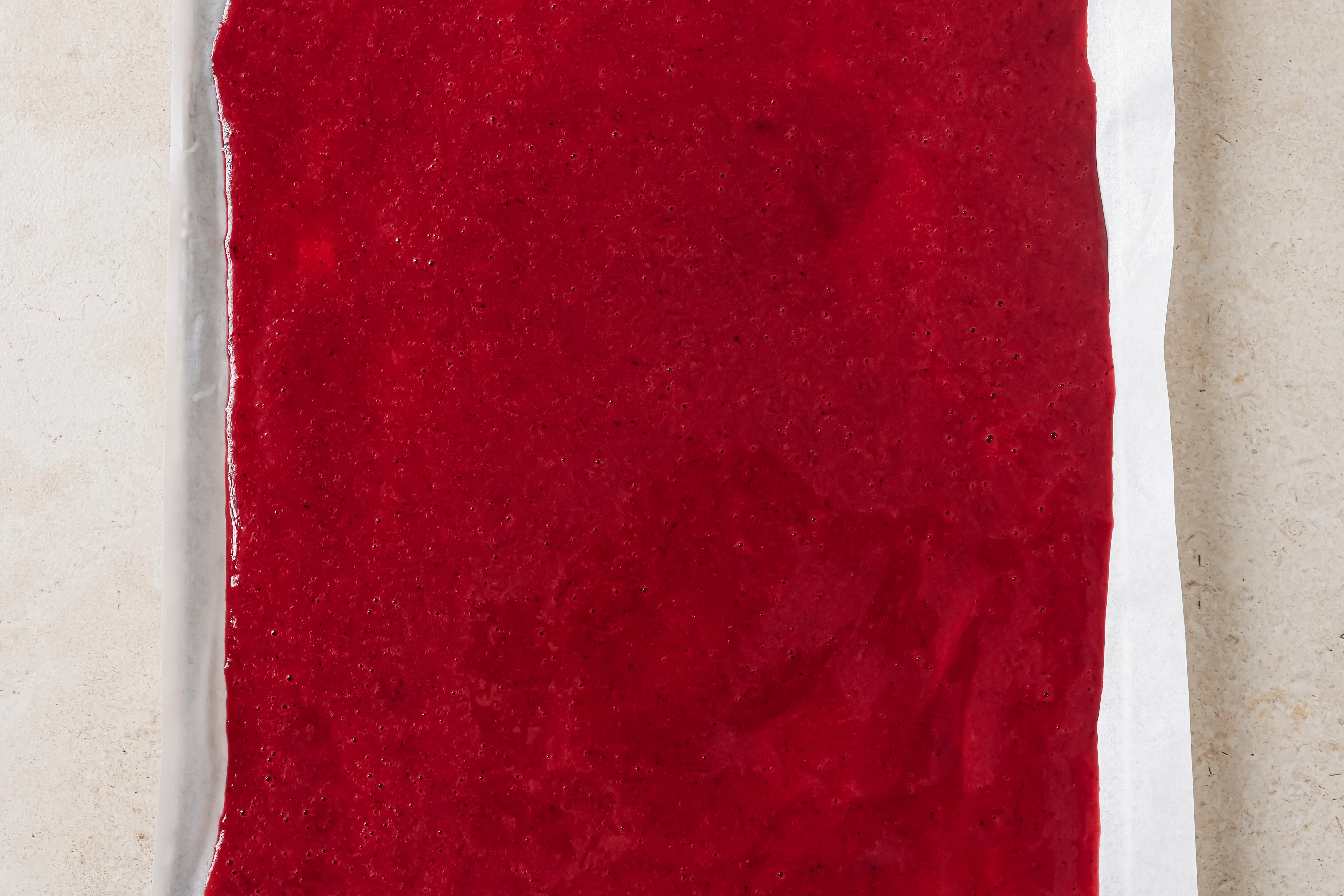 Fruit roll up puree on a large sheet pan, unbaked.