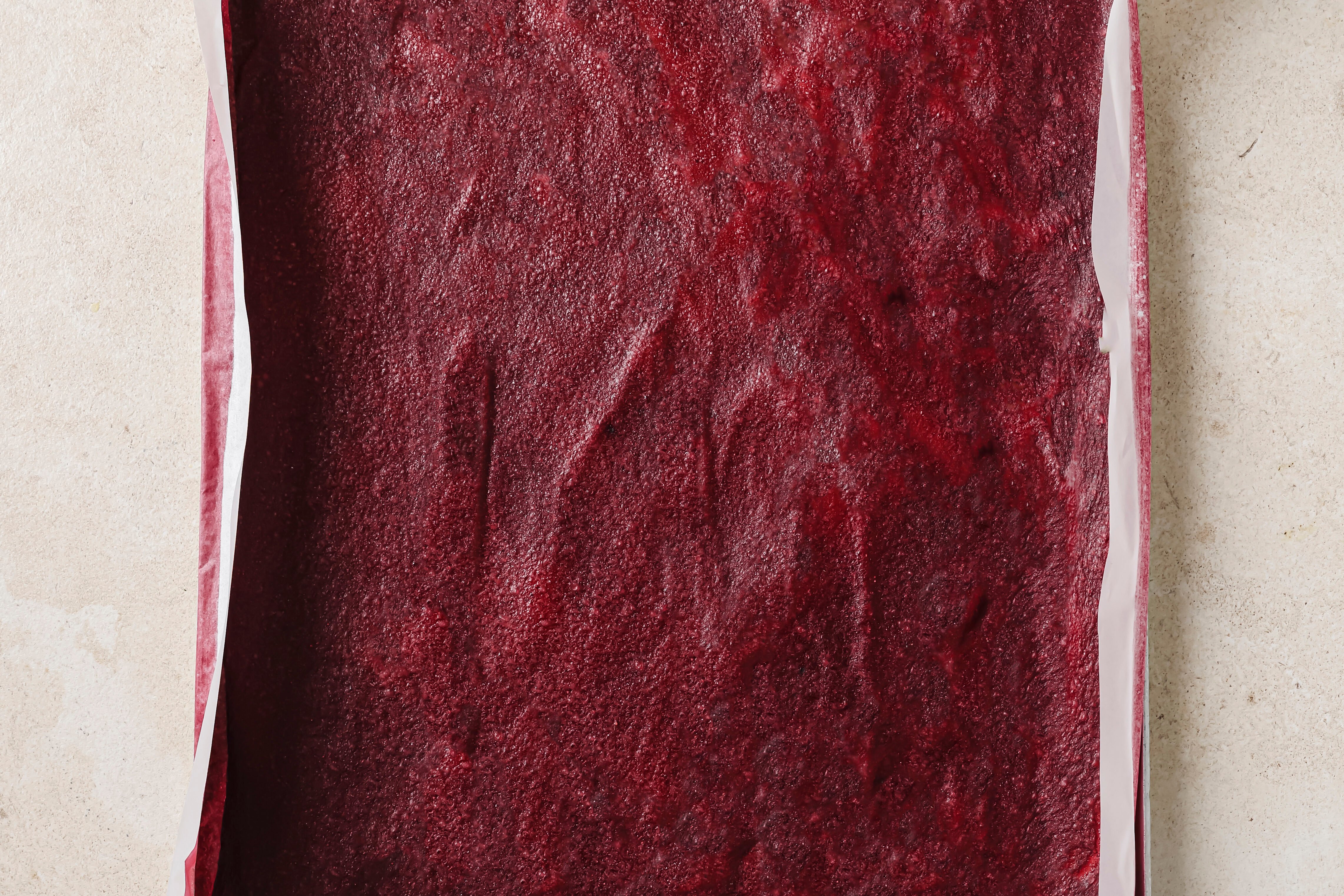 Fruit roll up fully dehydrated on on baking sheet.