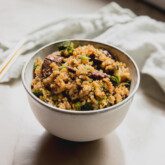 Beef and broccoli fried rice in a small white bowl.