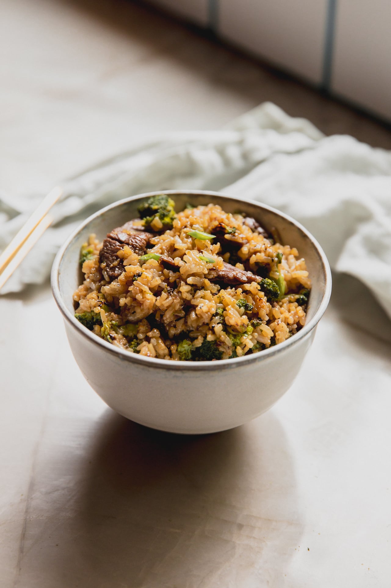 Beef and broccoli fried rice in a small white bowl.
