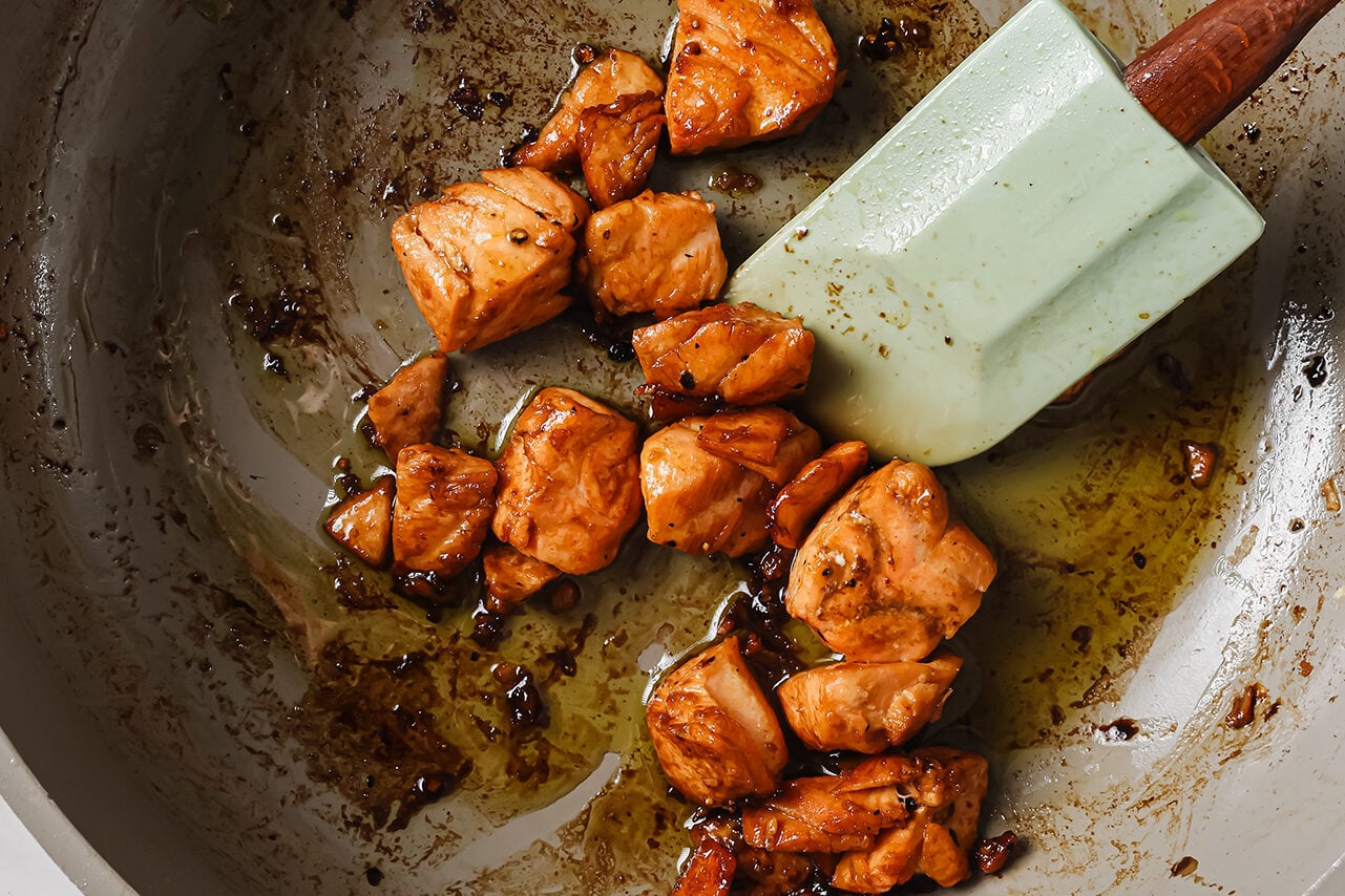 Salmon cubes cooked in a pan.