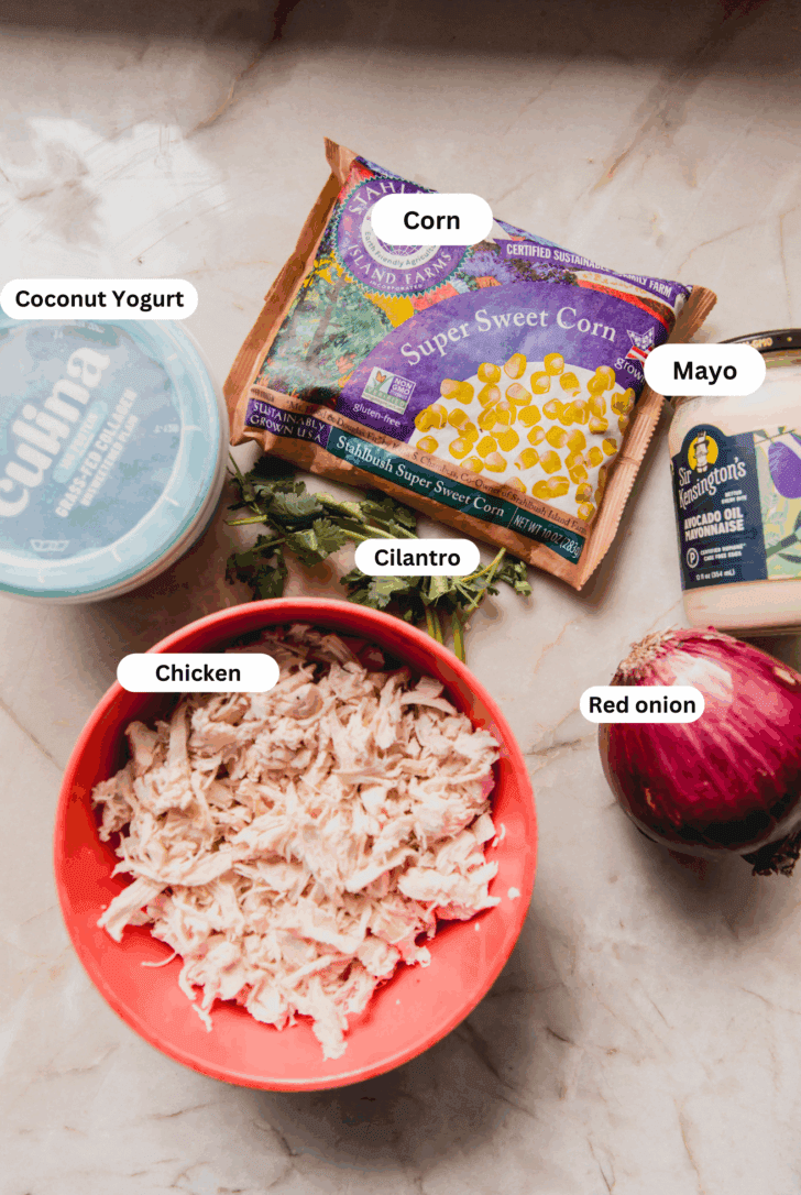 All the ingredients for making street corn chicken salad laid out on a counter before cooking.