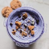 Blue cookie Monster Ice Cream topped with cookie crumbles in a ninja creami container.