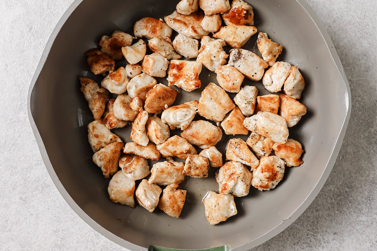 Cooked and cubed chicken crisped in a pan
