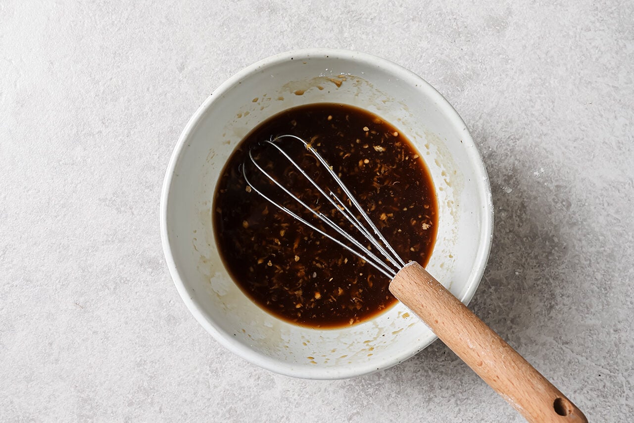 Lemon chicken sauce whisked in a bowl.