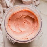 Peach ice cream in a ninja creami container.