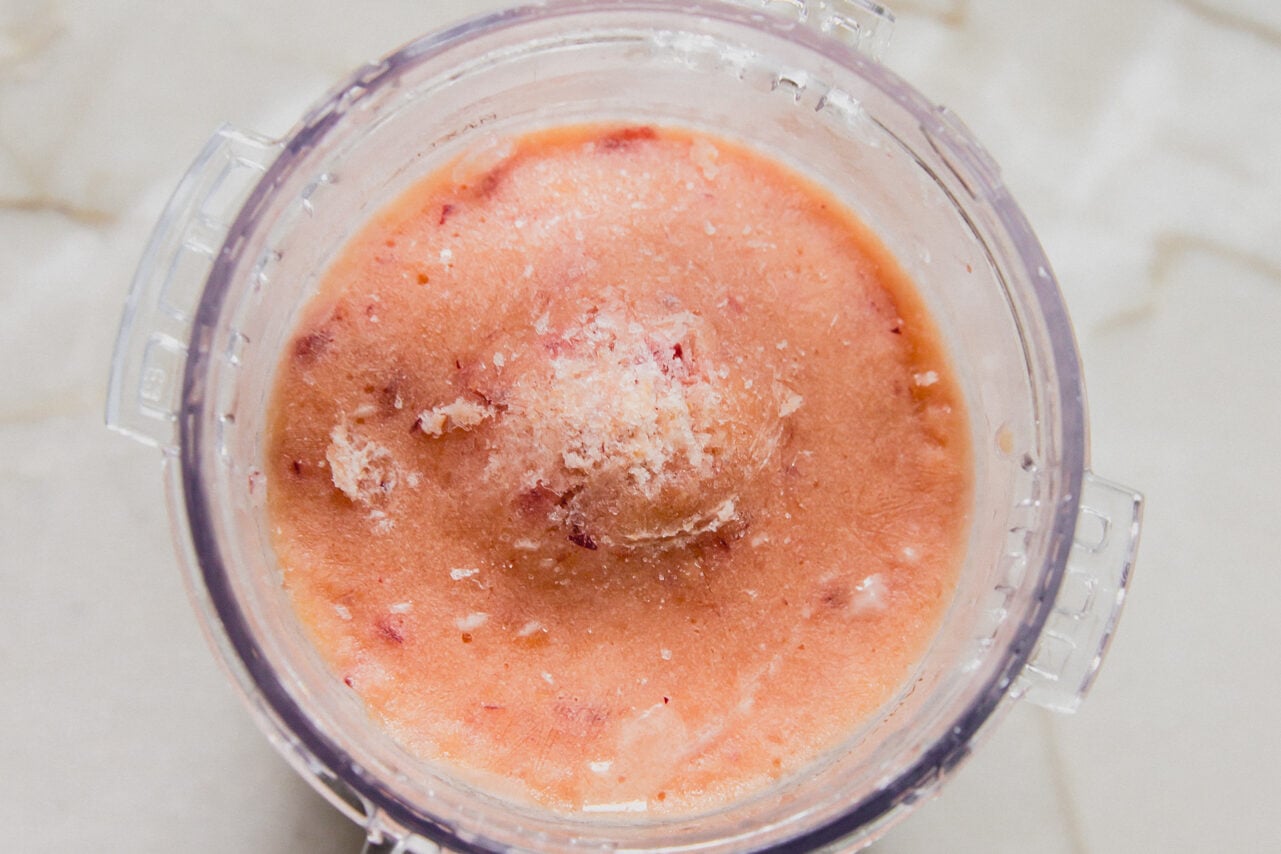 Peach ice cream in ninja creami, frozen before spinning.