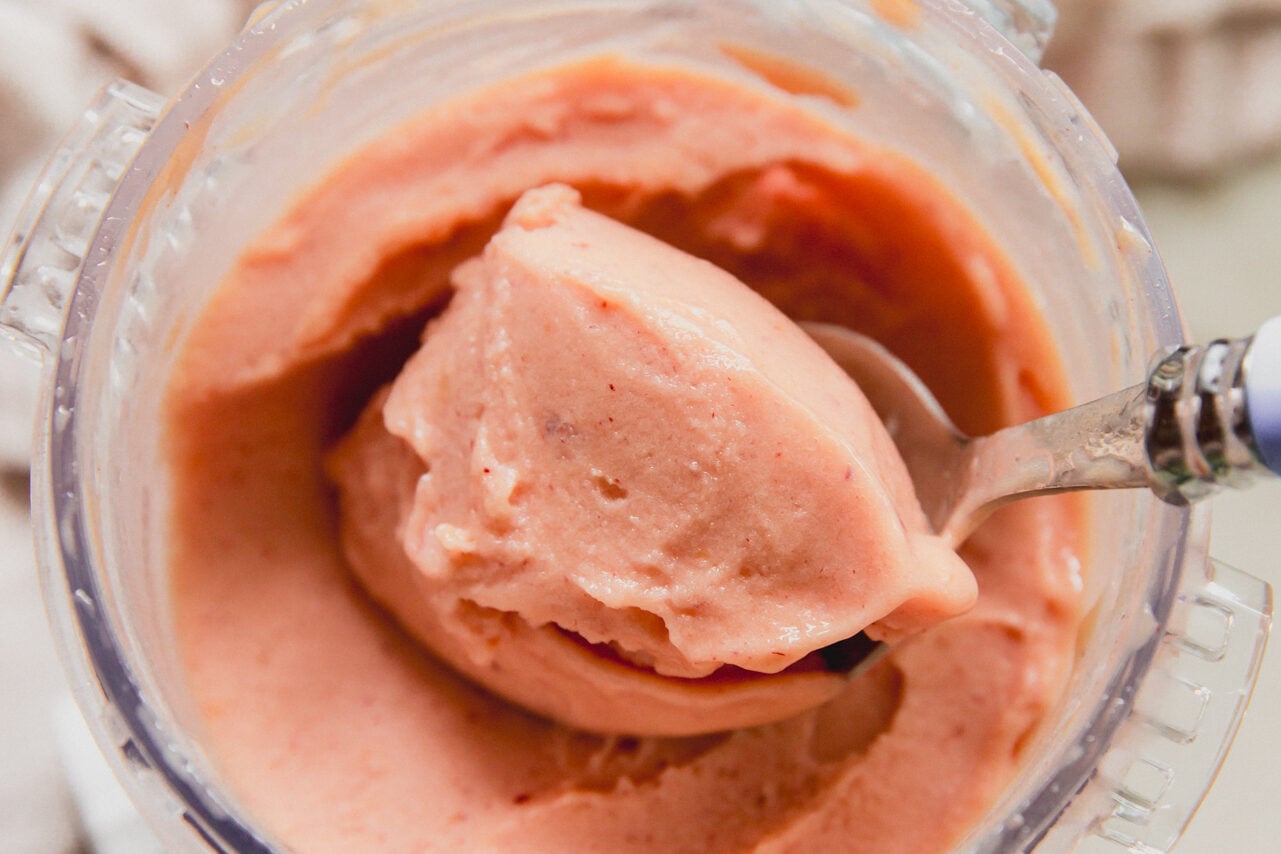 Ninja creami peach sorbet with a spoon.
