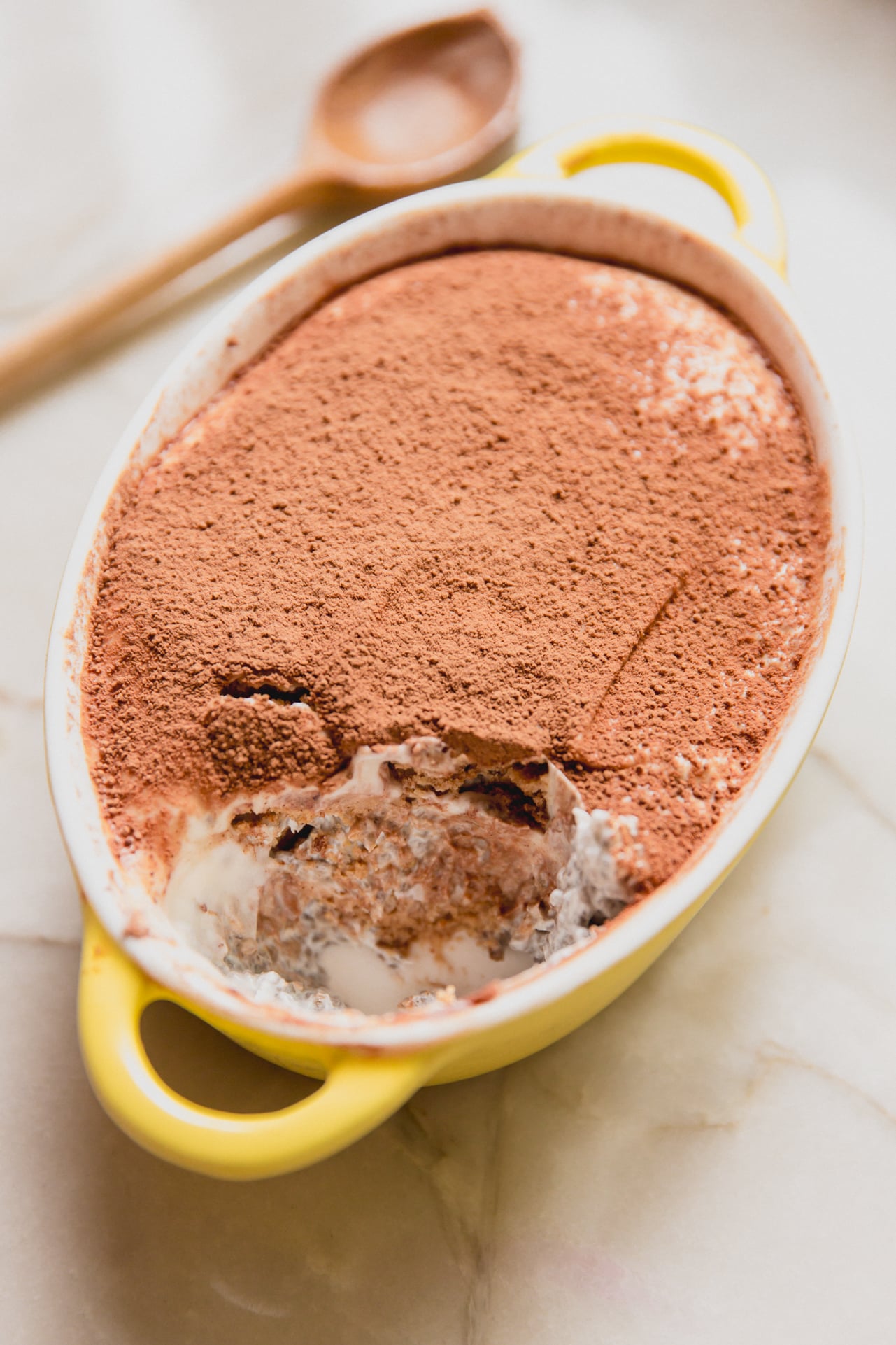 Protein tiramisu in a small yellow dish.