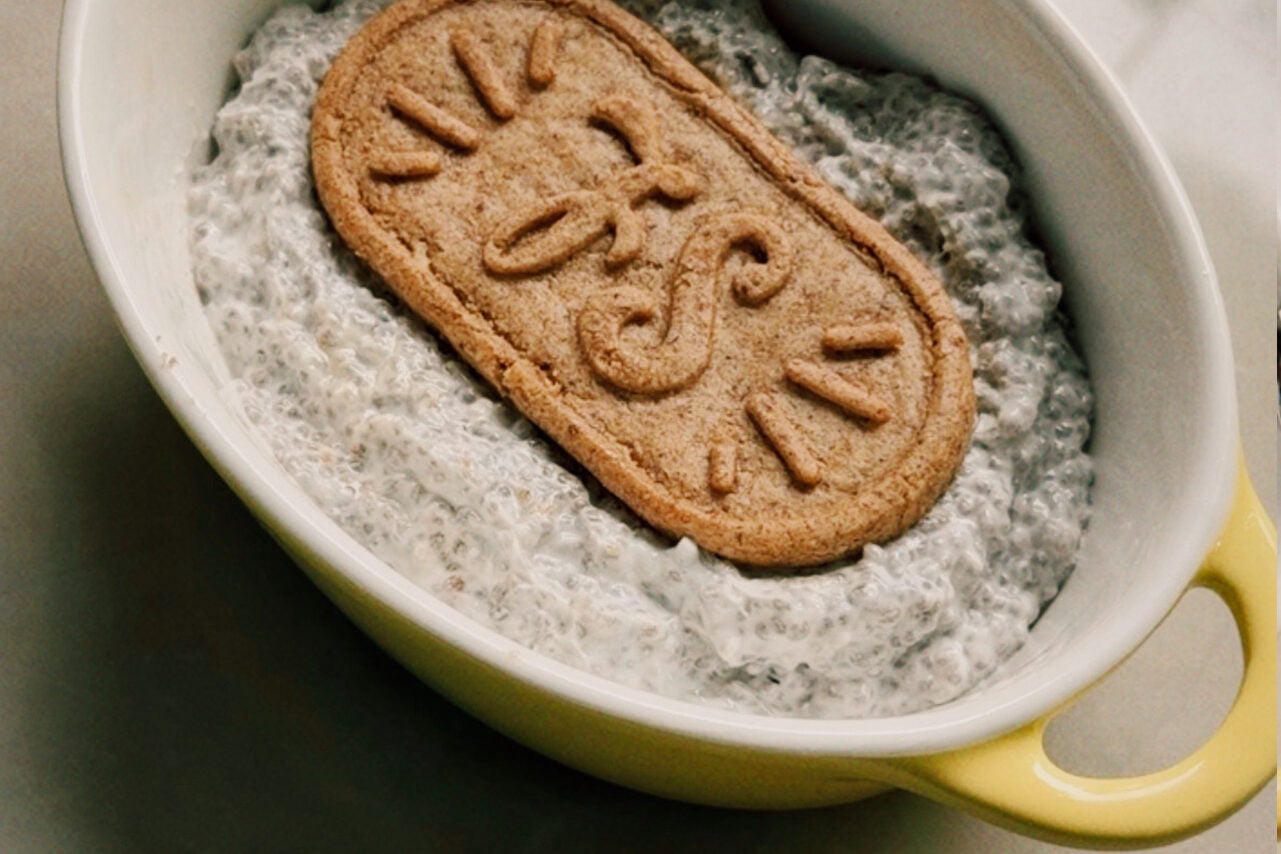 A ramekin filled with chia seed mixture with a breakfast biscuit on top.