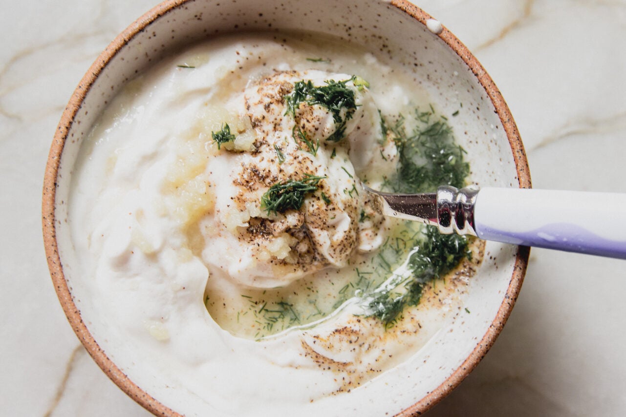 Yogurt, dill, lemon juice, and seasonings in a bowl.