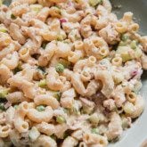 Tuna pasta salad with chopped veggies in a large blue bowl.