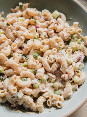 Tuna pasta salad with chopped veggies in a large blue bowl.