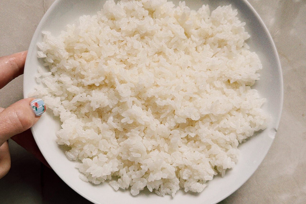 A white bowl filled with rice mixed with vinegar.
