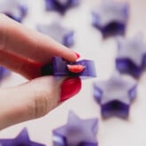 Blue raspberry gushers being held with the inside being squeezed out