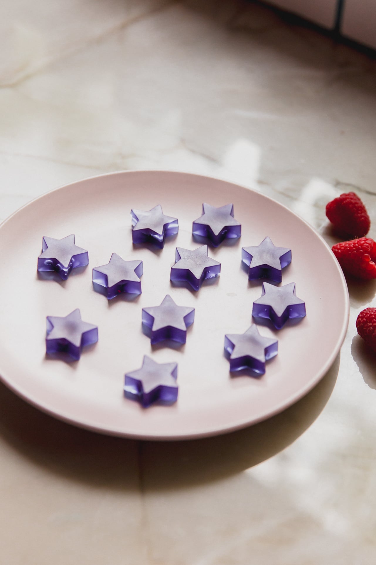 A white plate with blue raspberry gushers sitting on it.