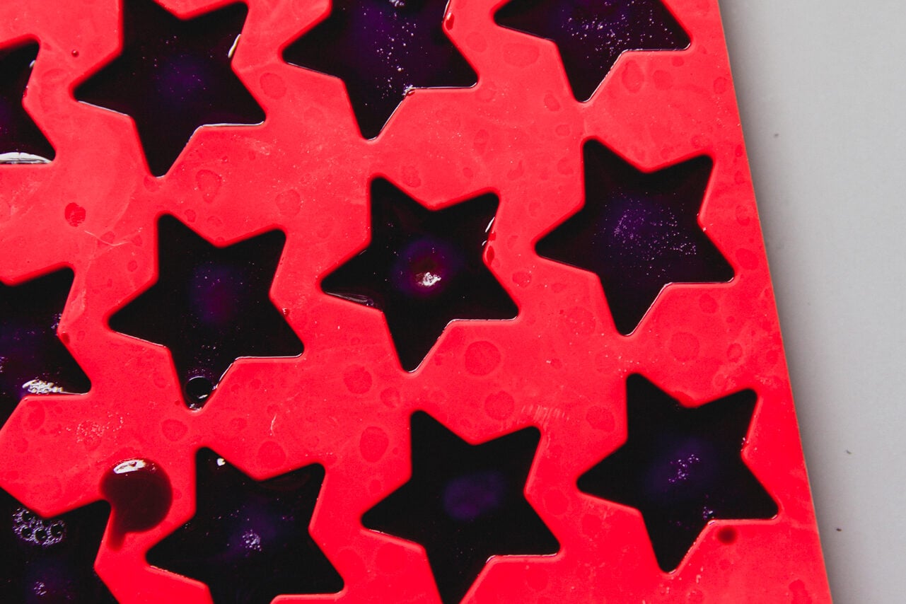 A red mold with the gushers set in it before being removed.