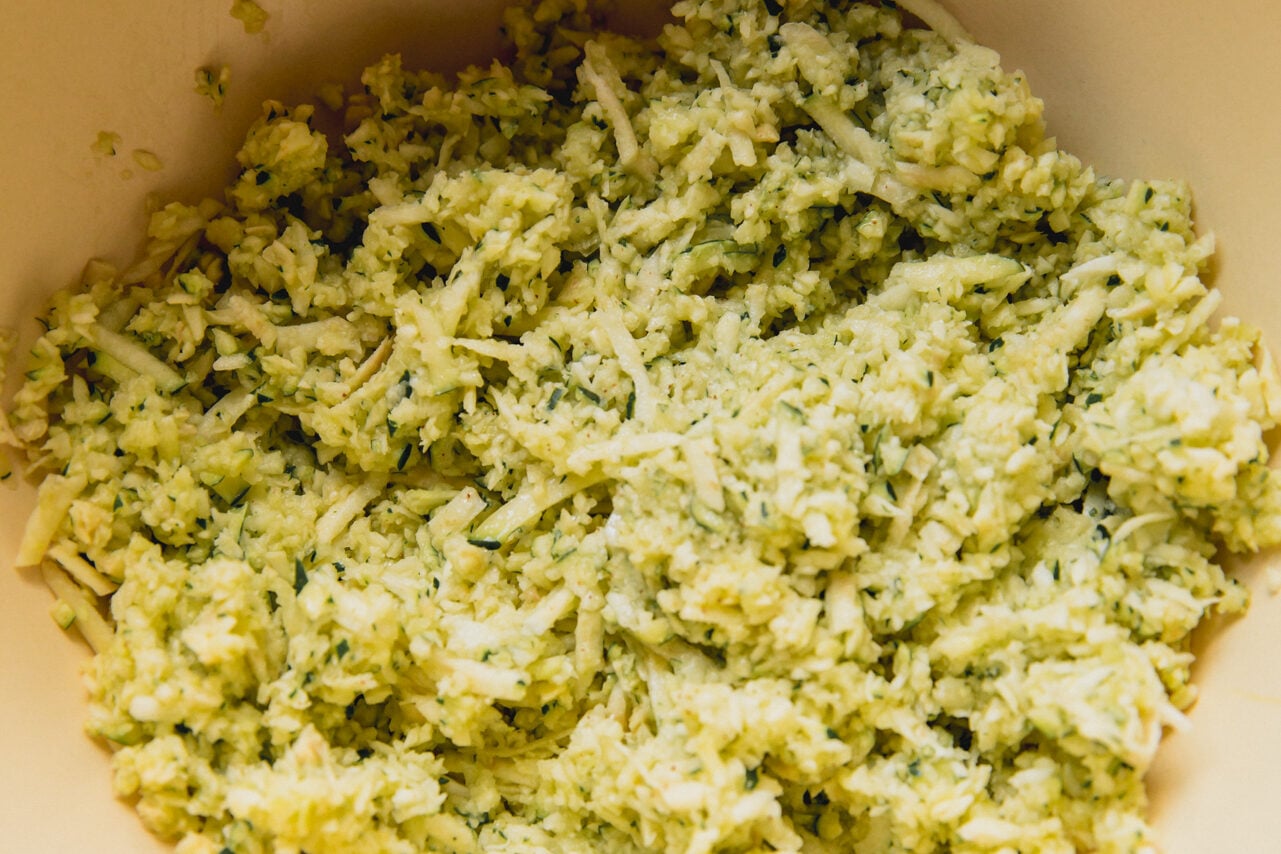 A bowl filled with shredded zucchini.