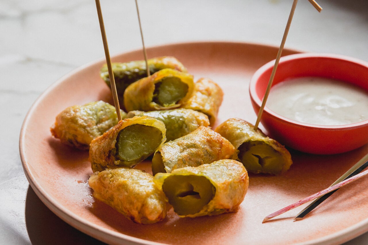 Rice paper fried pickles and ranch on a plate with toothpicks