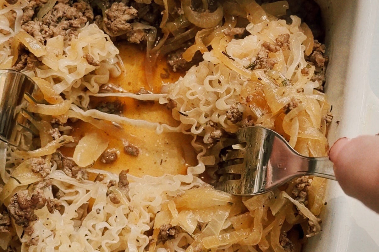 A fork pulling apart ramen bricks after some baking time.