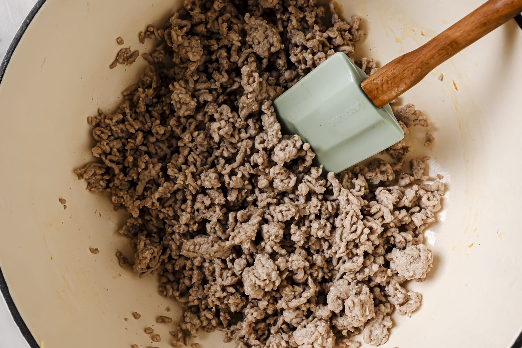 Cooked pork crumbled in a pot.